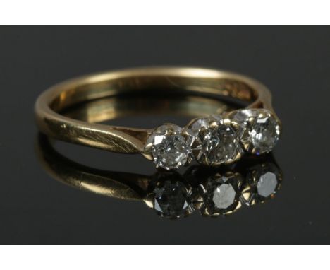 A 18ct gold three stone diamond ring (0.5 carat total) size N. 2.69g.  