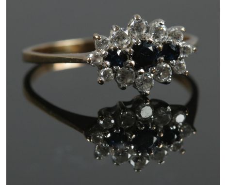 A 9ct gold ring with blue and white paste cluster design. Size P. Total weight: 1.66g. Stamped 375.  