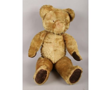 A vintage jointed teddy bear with growler. H: 55cm.  Growler will need attention as very faint. No name on bear and missing e