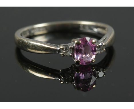 A 9ct white gold and diamond ring with pink stone centre piece. Size J 1/2. Total weight 1.32g.  