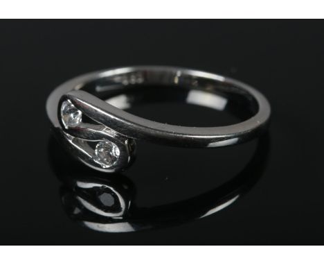 A 14ct white gold ring, tension set with two colourless stones. Size N 1/2. 2.3g.  