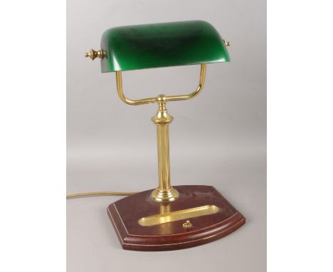 A vintage desk lamp, with green shade and pen tray.  