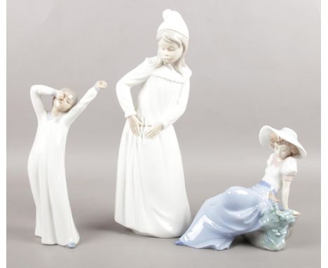 Three Nao female figures by Lladro. Two girls in nightgowns and young seated girl with bird. Tallest: H: 29cm.  All figures i