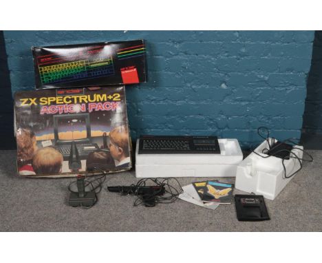 A boxed Sinclair ZM Spectrum +2 Action Pack. Comprising of joystick, power pack and light gun. Comes with Elite Firebird game