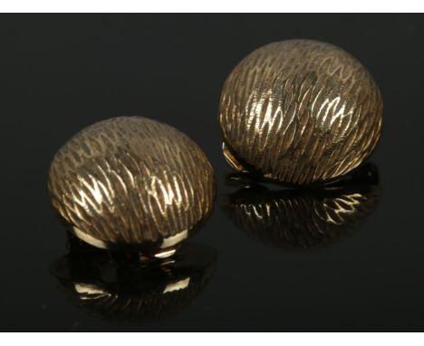 A pair of 9ct gold vintage clip on earrings with textured domes. 3.33g.  