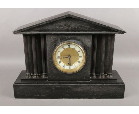 A Victorian slate mantel clock with roman numeral markers. (42.5cm wide)  