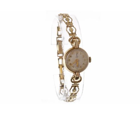 LADY'S TUDOR  ROYAL NINE CARAT GOLD MANUAL WIND WRIST WATCHthe round dial with applied gold Arabic numerals, sunken subsidiar