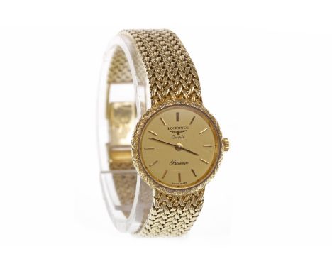 LADY'S LONGINES NINE CARAT GOLD MANUAL WIND COCKTAIL WATCHthe round gold coloured dial with applied baton hour markers, the 2