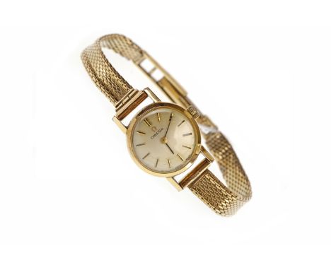 LADY'S OMEGA NINE CARAT GOLD MANUAL WIND WRIST WATCHthe round white dial with applied baton hour markers, on a mesh bracelet 