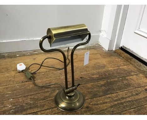 A brass brushed finish adjustable modern desk lamp on circular moulded base (h.36cm fully upright. d.15cm)