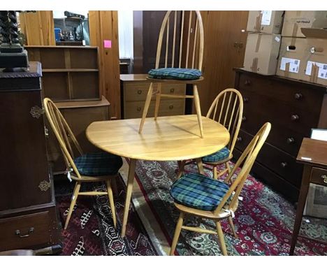 An Ercol light ash five piece kitchen/dining set comprising hoop back and spar back chairs and oval drop leaf gateleg table, 