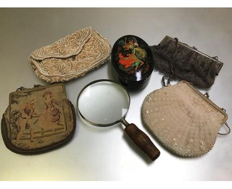 A mixed lot comprising a 1950s beaded evening purse, a 1930s machine made tapestry evening purse, a 1920s beaded belt purse, 
