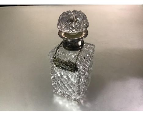 A crystal slice cut whisky decanter with silver collar, with mushroom shaped faceted stopper, complete with chased brandy lab