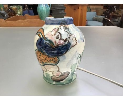 A 1930s pottery ribbed baluster table lamp base with original pierced side inlet hole, decorated with a Piglet and Giraffe pl