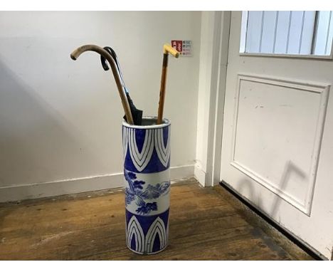 A modern Chinese porcelain cylinder stick stand with stylised landscape panel, including walking sticks, umbrellas etc. (h.58