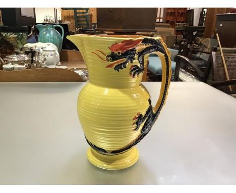 A Burleigh ware pottery ribbed 1930s style jug with four claw dragon handle, yellow ground (h.25cm x d.14cm)