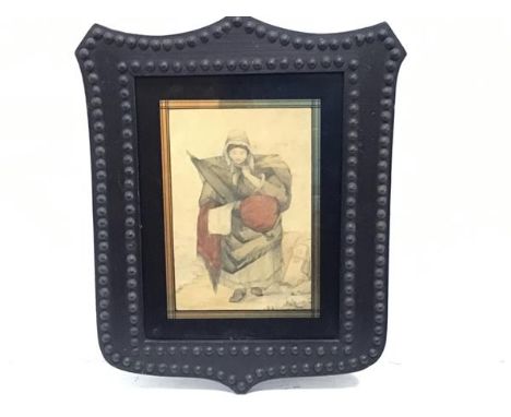 A 19thc pencil sketch of a women highlighted with colour, mounted in shield shaped brass studded frame (18cm x 13cm excluding
