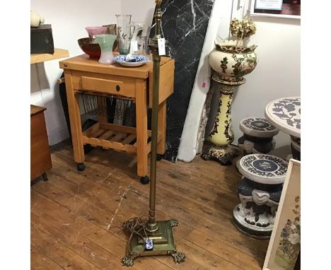 An Edwardian cast brass Corinthian column adjustable oil floor lamp, converted to electricity, raised on stepped base and paw