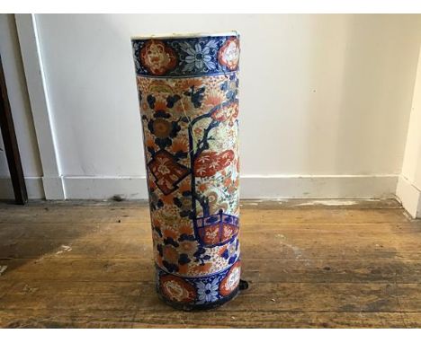 An early 20th Japanese Imari umbrella/stick stand of cylinder form, heavily restored, losses (h.62cm d.23cm)