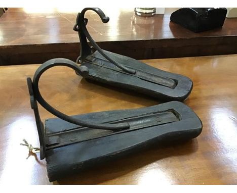 Equine interest: a pair of unusual early 20thc Estate made saddle racks, each rack composed of an ebonised rest fitted with w