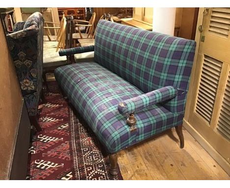 An Edwardian oak framed two seater hall sofa with upholstered panel back, arms and stuffover seat in tartan fabric, on turned