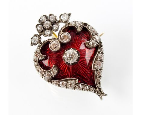 An early 20th century red enamel and diamond heart shaped pendant/brooch, designed as a red enamel heart set within central o