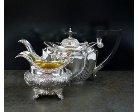 A Victorian silver cream jug, BD, London 1838, with embossed decoration and engraved initials, 9.5cm high, together with an E