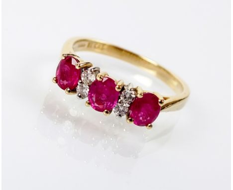 A seven stone ruby and diamond ring, designed as three oval mixed cut rubies interspersed with four brilliant cut diamonds, a