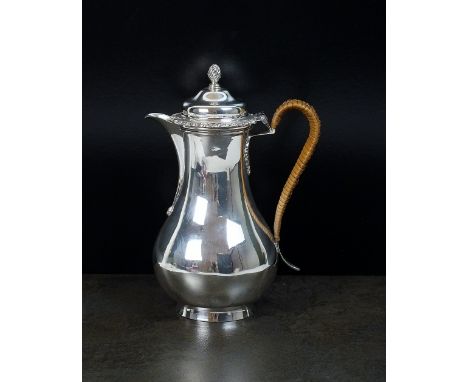 An Edwardian baluster silver hot water jug, John Henry Rawlings, London 1903, the domed hinged cover with wrythen finial, wic