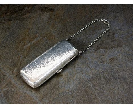 An Edwardian silver mirror compact, S Blanckensee & Sons Ltd, Birmingham 1909, of elongated rectangular hammered form, the si