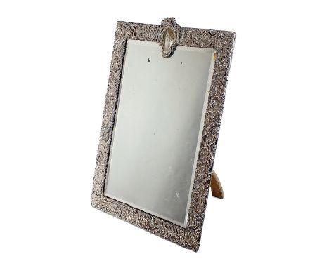 A large Edwardian silver mounted mirror, Goldsmiths & Silversmiths Co Ltd, London 1905, of rectangular form with pierced scro