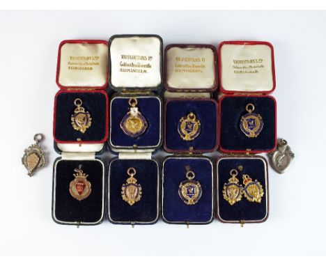 A collection of nine 9ct gold and polychrome enamel medals in cases, weight approx. 90gms, together with two silver medals (1