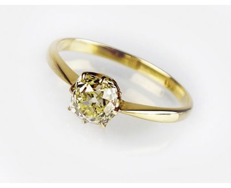 A single stone fancy yellow diamond ring, the old cut light fancy yellow diamond claw set in yellow metal to yellow metal sha