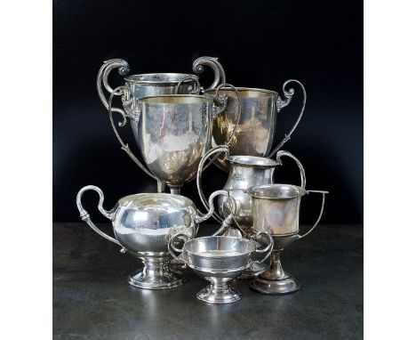 A collection of seven silver presentation trophy cups, four hallmarked London and three hallmarked Birmingham, all with twin 