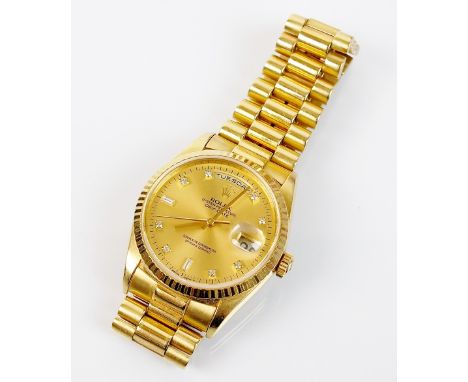 A Gentleman's 18ct gold Rolex Oyster Perpetual day/date Superlative Chronometer wristwatch, the champagne dial with diamond s