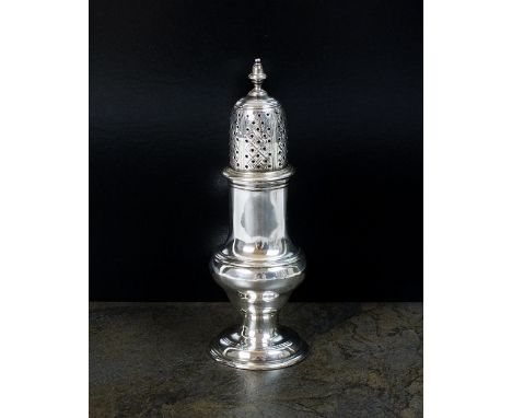 A Georgian silver pepperette, London, marks rubbed, circa 1760, of baluster form with engraved crest, the pierced cover with 