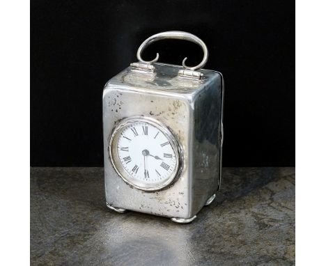 An Edwardian silver cased timepiece, HM, 1901 the circular white enamel dial with black Roman numerals, the case with handle 