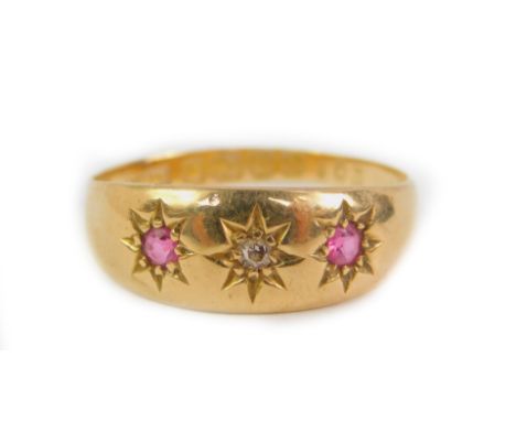 An 18ct gold ruby and diamond three stone gypsy ring, illusion set, size O, 2.7g.