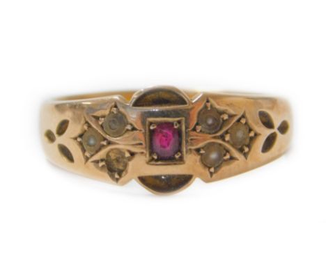 A Victorian 15ct gold gypsy ring, set with central garnet, surrounded by seed pearls (one missing), part pierced shoulders, s