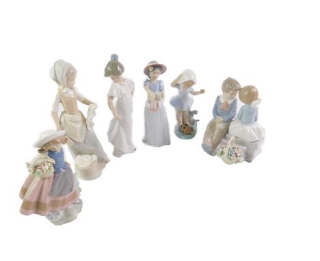 Lladro Nao and other porcelain figures, including a girl with basket of flowers, and another girl holding slippers and boxes.