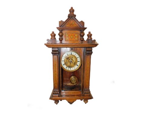 An American painted walnut late 19thC wall clock, of architectural form, brass dial with enamel chapter ring, bearing Roman n