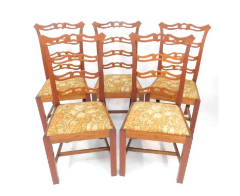 A set of five Chippendale style mahogany dining chairs, with pierced ladder back, foliate printed fabric drop-in seats, raise