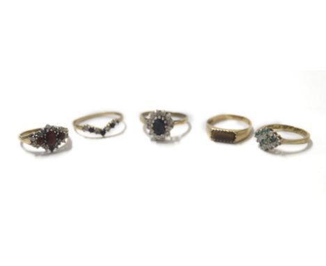 A 9ct gold and garnet three stone ring, in a surround of zircons, size K, 9ct gold and sapphire wishbone ring, size O, 9ct go