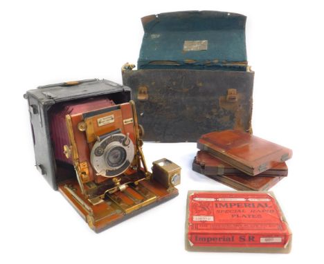 A Sanderson Patent quarter plate hand camera, with a Korilos shutter and Ensign Anstigmat 4.75" lens with 4DDS, and a box of 