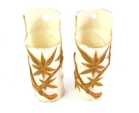 A pair of late 19thC Royal Worcester porcelain wall mounted vases, c1882, of cylindrical bamboo form, printed marks, 15cm H.