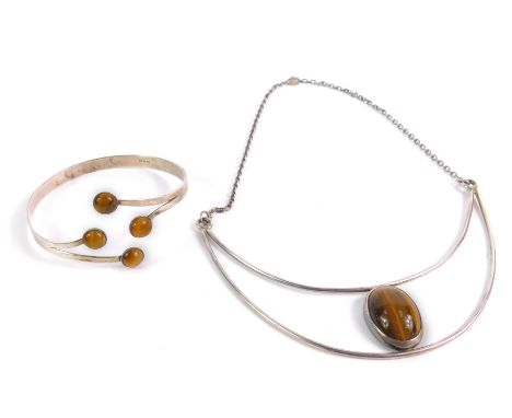 A silver and tiger's eye necklace on chain, together with a tiger's eye and silver bangle, makers initials FG, London 1976 an
