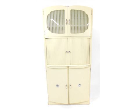 A Shefco cream painted wooden and glass larder cupboard, with two cupboard doors enclosing a single shelf above a pair of tam