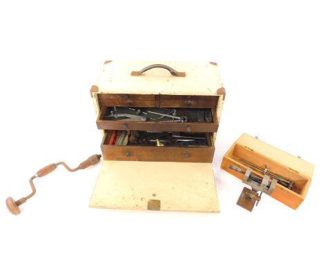 A cream painted tool chest, of four short and three long drawers, 28.5cm Hm 43cm W, 22cm D, containing drawing instruments, t