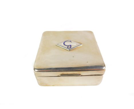A silver square cigarette box, decorated to the lid with a plaque bearing a smoking cigarette and the letter G in blue and wh