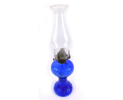 A Continental blue glass oil lamp, with a clear glass chimney, 38cm H.